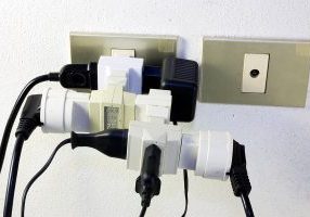 bunch of adapters and plugs on electrical socket - bad electrical 
connection - overloaded electric terminal
** Note: Slight blurriness, best at smaller sizes